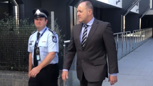 Senior Sergeant Scott Stahlhut (right) leaves Toowoomba Magistrates Court on Wednesday afternoon.