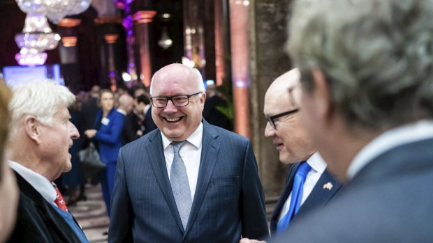 Australia's High Commissioner to the UK George Brandis welcomes Stanley Johnson, father of Prime Minister Boris Johnson, (left) and US ambassador Woody Johnson (right) to Australia House for Australia Day celebrations in London.