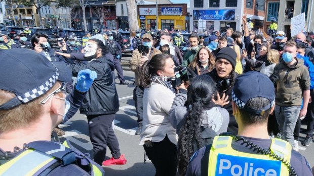 Police and anti-lockdown protesters outside the Queen Victoria Market on September 13 last year.