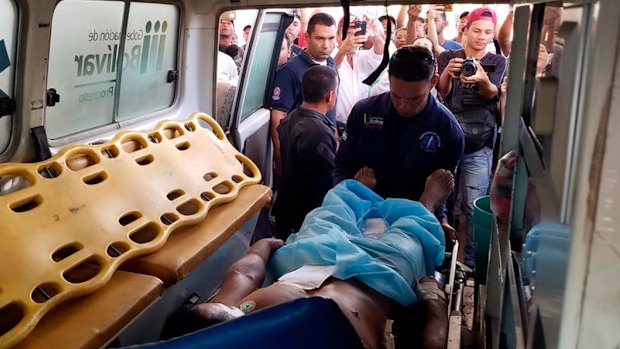 A Pemon indigenous man is loaded into an ambulance after he was shot and wounded when clashes erupted  in Santa Elena, Venezuela. 