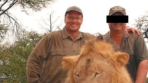 American dentist and big-game hunter Walter Palmer poses with the corpse of a lion.