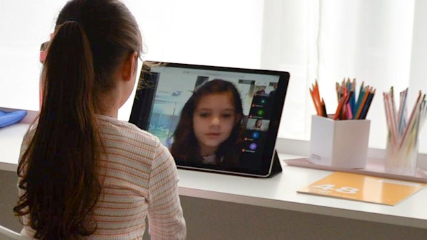 Evie Macheda, five, learns from home on the first day of term two.