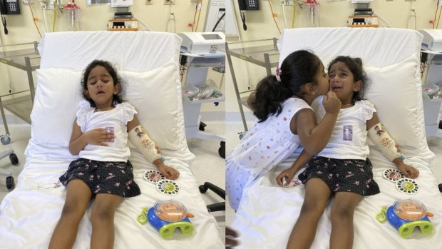 Tharnicaa and her sister Kopika in hospital on Christmas Island on June 6. 