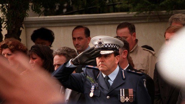 Chief Commissioner Neil Comrie salutes Gary Silk on his last journey.