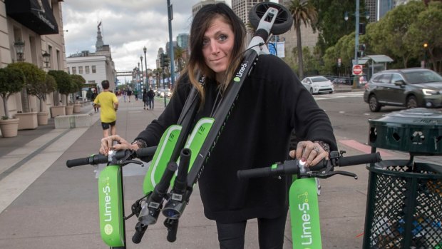 "Juicer" Livia Looper pushes Lime scooters in San Francisco, California.