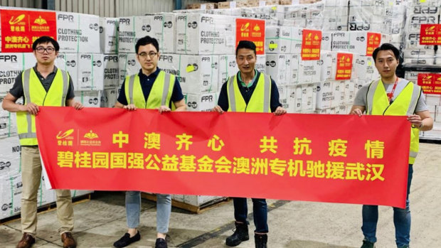 "China-Australia work as one together to fight epidemic" reads the banner being held by Risland’s CEO Dr Guotao Hu (second from left), Ray Zi, general manager, human resources & administration and former communications manager Isaac Huo.