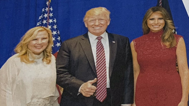 One of the photos contained in the affidavit shows Trump and first lady Melania Trump posing for a photo with Sherry Li during a fundraiser 