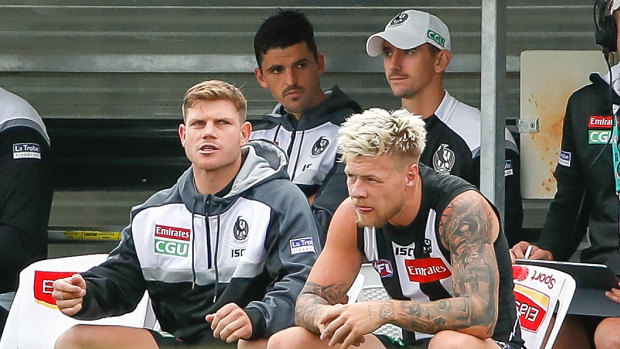 Side show: Collingwood's Scott Pendlebury (back left), Taylor Adams (front left) and Jordan De Goey (front right) watch on during the Marsh Community Series match against St Kilda at Morwell Reserve.