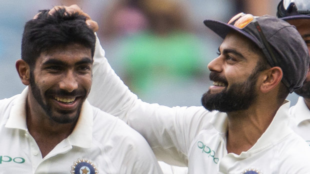 Man of the match: India captain Virat Kohli congratulates Jasprit Bumrah after one of his nine wickets for the match. 