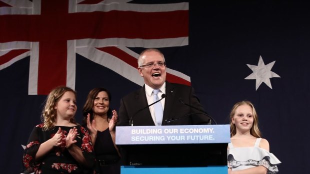 Scott Morrison takes to the stage with wife Jenny and children Abbey and Lily to declare victory.