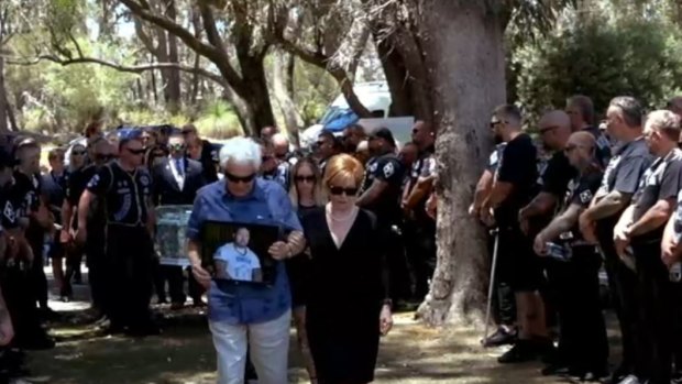 A photo of Nick Martin leads the start of the funeral.