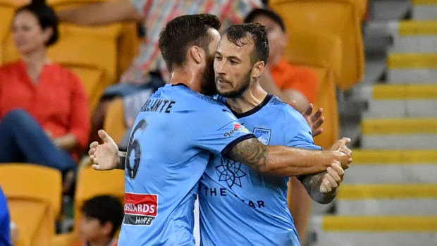 Double act: Sydney FC striker Adam Le Fondre is embraced by Josh Brillante after restoring Sydney's lead against Brisbane.