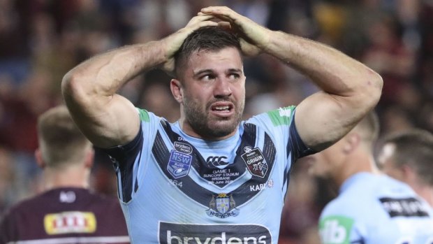 Ouch: James Tedesco reacts to Dane Gagai’s try. 