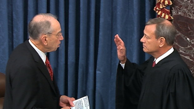 President Pro Tempore of the Senate Senator Chuck Grassley swears in Supreme Court Chief Justice John Roberts as the presiding officer for the impeachment trial of President Donald Trump.