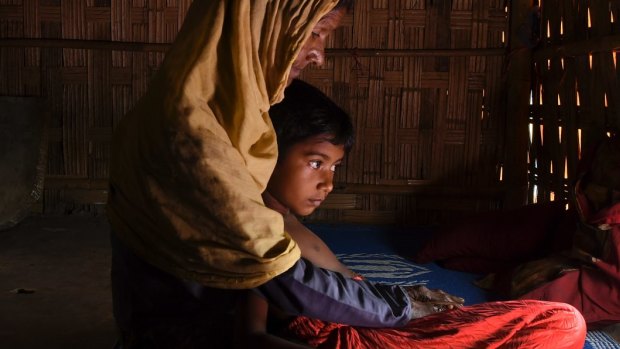 A Rohingya woman with her orphaned granddaughter at a refugee camp in Bangladesh.
