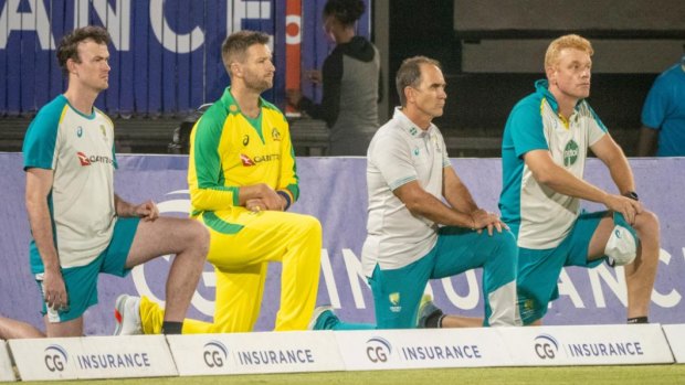 The Australian team takes a knee before a T20 clash with the West Indies.