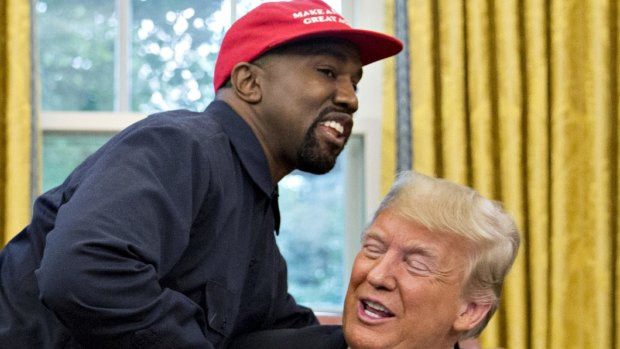 Rapper Kanye West, left, shakes hands with US President Donald Trump during a meeting in the Oval Office of the White House in Washington, DC.