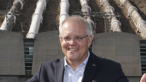 Prime Minister Scott Morrison poses for photos during a visit to the Snowy Hyrdo Tumut 3 power station.

