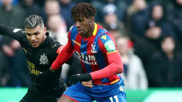 In demand: Wilfried Zaha, right, and Newcastle United's DeAndre Yedlin battle for the ball.