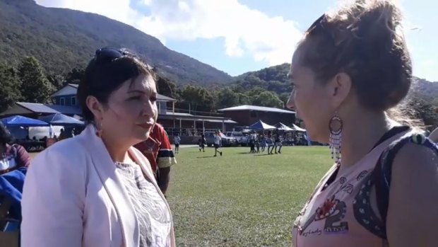 Environment Minister Leeanne Enoch speaking with a Stop Adani protester.