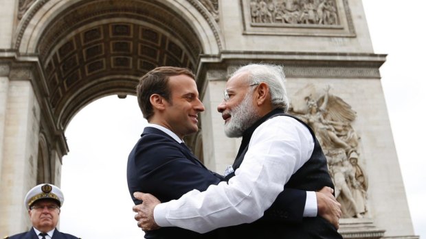 Indian Prime Minister Narendra Modi hugs French President Emmanuel Macron, at the Arc de Triomphe in Paris. The pair put forth a common front on the need to fight climate change.