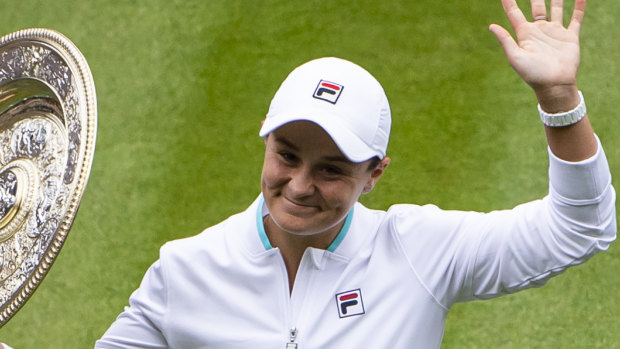 Ash Barty lifts the trophy after winning Wimbledon.