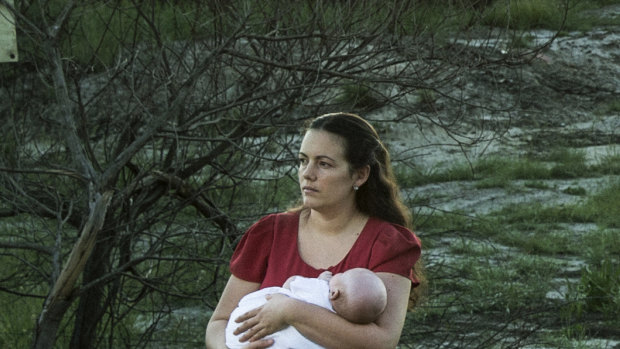 Samantha Kelly with her baby William near one of the contaminated drains near RAAF base Williamtown. 