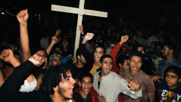 Coptic Christians chant slogans during a protest following the Islamic State attack.