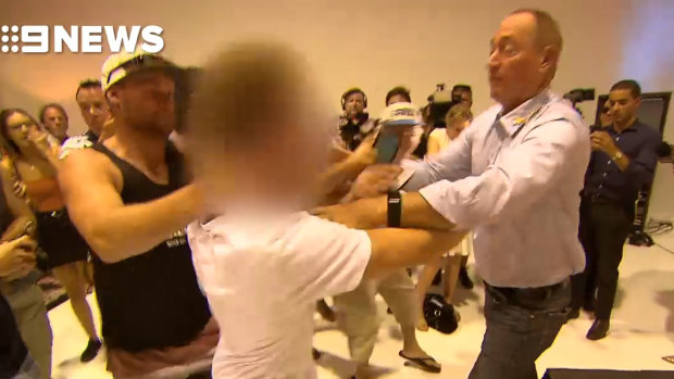 Senator Fraser Anning reacts to being egged from behind during a media conference.