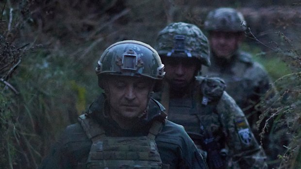 Ukrainian President Volodymyr Zelenskiy surrounded by servicemen as he visits the war-hit Donetsk region, eastern Ukraine in October. 