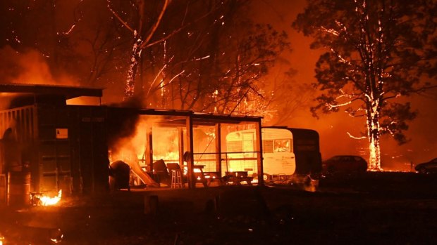 Firefighters overwhelmed by flames at a bushfire in Orangeville, 5 December 2019.