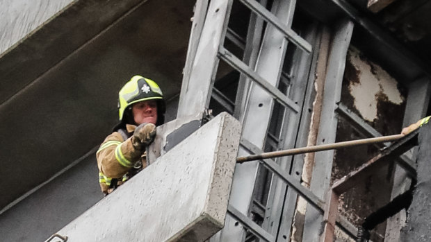 Firefighters inspect the damage at Melbourne’s Neo 200 building.