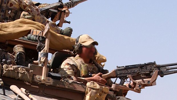 An Australian surveillance reconnaissance vehicle patrols an operating base in Afghanistan in 2005.