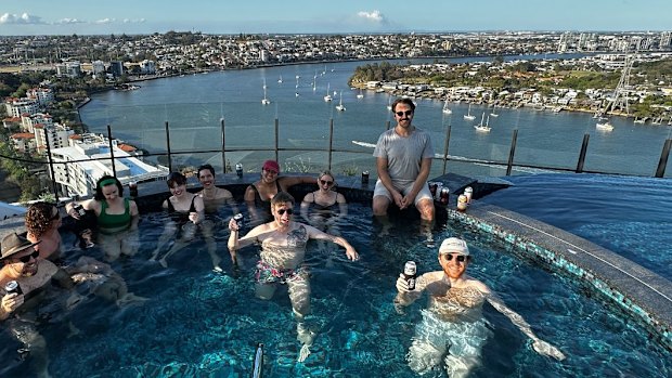 Friends relaxing in a rooftop pool in Newstead.