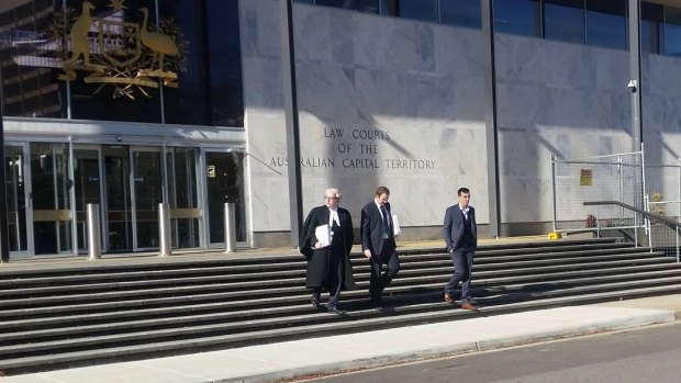 Kerim Hidic, 22, (far right) leaves the ACT Supreme Court with his lawyers after a jury found him guilty of recklessly inflicting grievous bodily harm.