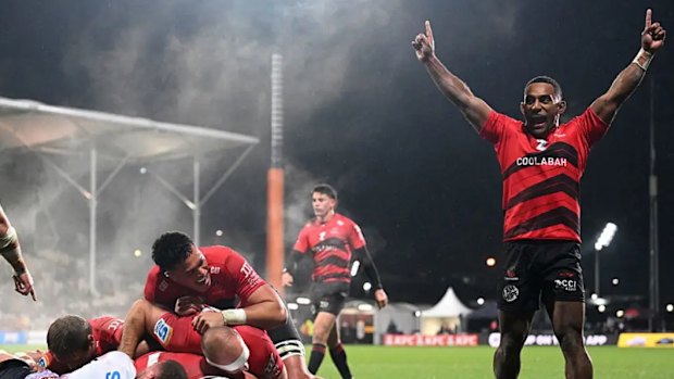 Sevu Reece of the Crusaders celebrates after Tamaiti Williams scores against the Reds.