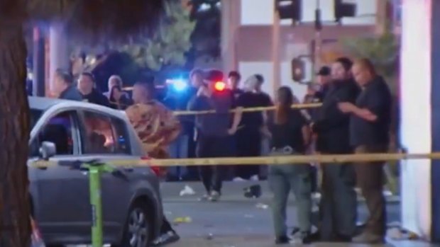 A car is seen on Santa Monica Boulevard where at least 20 people are reported to have been struck.