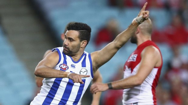 Celebration: Lindsay Thomas lands a goal against the Sydney Swans as North Melbourne book a preliminary final berth.