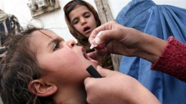 A child is vaccinated against polio in Afghanistan, one of three nations where the disease remains endemic.