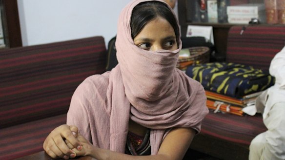 Bitiya, who agreed to be photographed with her face covered, in her village.