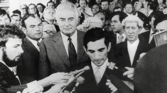 Gough Whitlam stands behind David Smith, the secretary to the Governor-General, as he reads the proclamation dissolving parliament following the dismissal of the Whitlam government.
