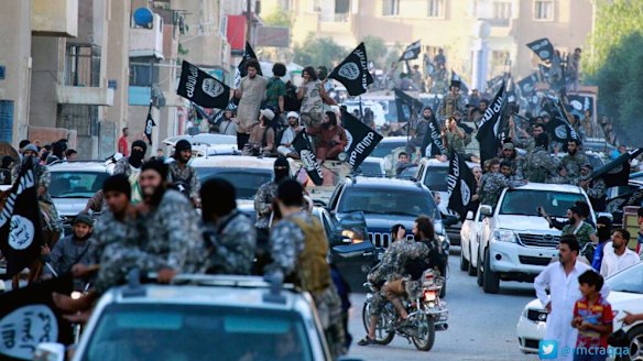 Islamic State fighters parade in Raqqa, Syria.