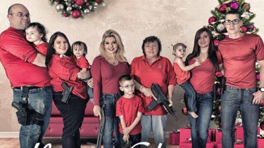 Nevada Republican Michele Fiore, third adult from left, as she appears in her family Christmas card featuring guns.