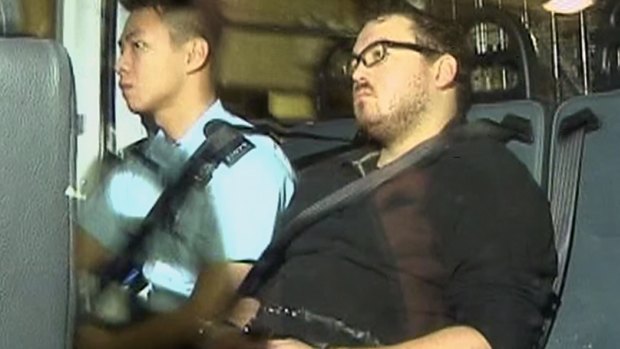 Off to court: Rurik Jutting, a 29-year-old British banker who has been charged with two counts of murder, sits in a police van in Hong Kong.