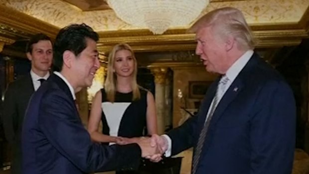 Japan PM Shinzo Abe and Donald Trump meet in the presence of Trump's daughter, Ivanka.