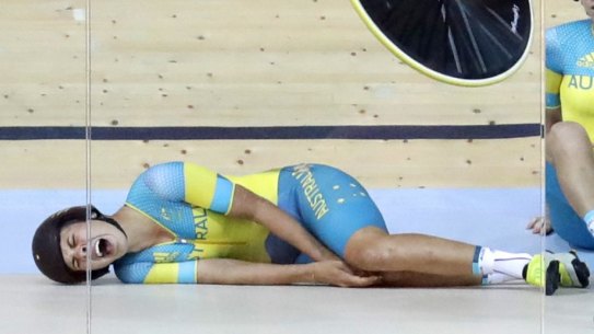 Horror start: Mel Hoskins cries out in pain after a training crash at the Rio velodrome.