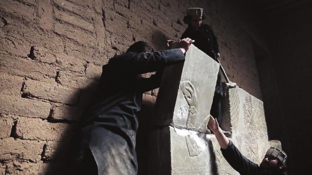 This image taken in April 2015 is said to show Islamic State militants destroying relics in the ancient Assyrian city of Nimrud in northern Iraq. 