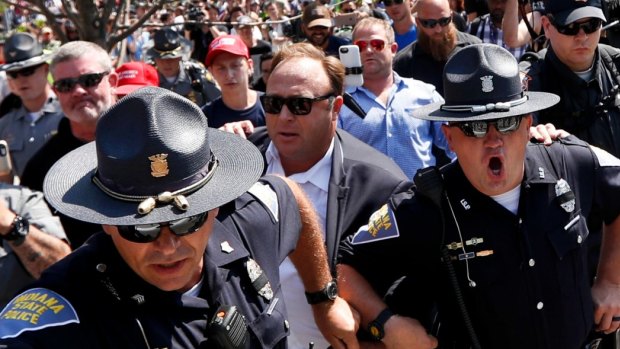 Alex Jones, second from right, an American conspiracy theorist in Cleveland, during the second day of the Republican convention. 