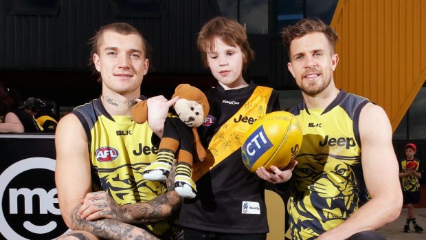 Dustin Martin (left) and Brett Deledio with Isaiah Muller after a Richmond  training session.