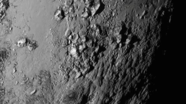 Icy mountains are revealed for the first time on Pluto in the first high-resolution photo sent back from the New Horizons probe.